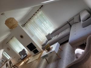 a living room with a couch and a table at Bujtina Bezhani Gjinar in Elbasan