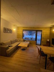 a living room with a couch and a table at Mavrovo Apartment in Mavrovo