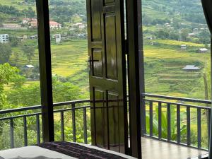 an open door to a balcony with a view at Hmong house Sapa in Sa Pa
