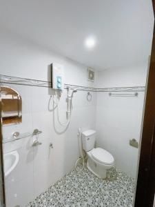 a bathroom with a shower and a toilet and a sink at Thùng Thép Homestay in Vung Tau