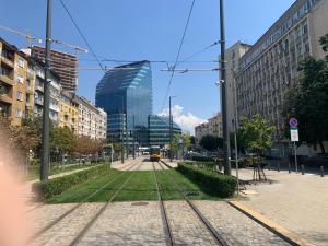 een straat met treinrails in een stad bij Sweet dreams Parking by request in Sofia