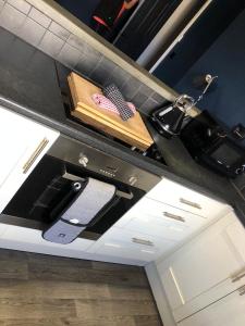 a kitchen counter with a sink and a cutting board at Raby Apartment in Darlington