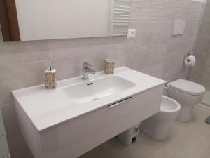 a bathroom with a white sink and a toilet at A Casa di Amici in Arezzo