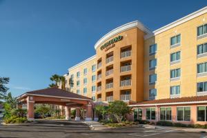 an exterior view of a hotel with a parking lot at Courtyard Jacksonville Orange Park in Orange Park