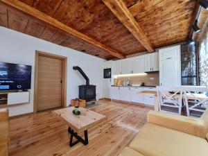 a living room with a couch and a table at Montenegro Dream House in Žabljak