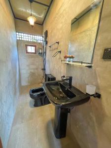 a bathroom with a sink and a toilet at Amandawa Eco in Gampaha