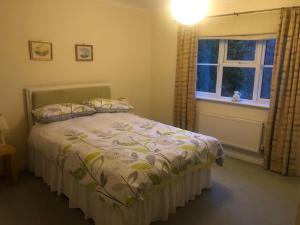 a bedroom with a bed and a window at Cherry Trees in Muxton +9 photos
