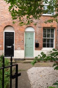 a brick building with a green door and a window at City Centre 2 Bed House Perfect for Contractors with Free Parking in Nottingham