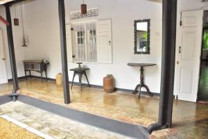 an empty room with a table and a desk in it at Village Headman's Five Bedrooms Entire Bungalow in Bentota