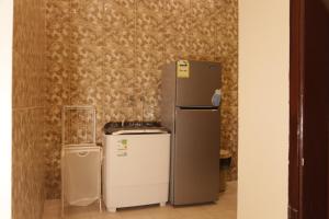 a refrigerator and other appliances in a room at Spacious Apartments at Basla St 3 mins from King Fahd Stadium in Riyadh