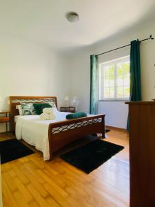 a bedroom with a bed and a large window at Casa da Fazenda in Santa Cruz das Flores