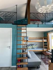 a bunk bed with a staircase in a room at Guest house at Baltic Sea Oskarshamn in Oskarshamn