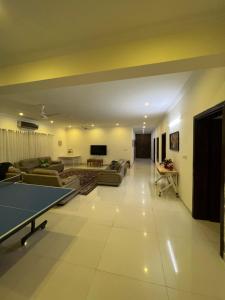 a large living room with couches and a tv at DHA 2 Islamabad in Islamabad