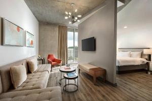 a living room with a couch and a bed at Twelve Midtown, Marriott Autograph Collection in Atlanta