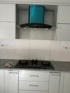 a kitchen with a stove top oven in a kitchen at DHA 2 Islamabad in Islamabad