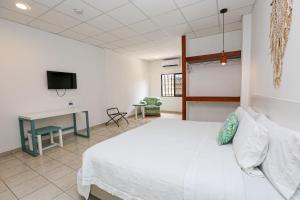 Postel nebo postele na pokoji v ubytování Hotel & Suites Arges - Centro Chetumal