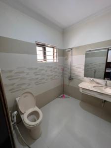 a bathroom with a toilet and a sink at DHA 2 Islamabad in Islamabad