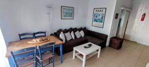 sala de estar con sofá y mesa en APARTAMENTO COVES NOVES, en Port d'Addaia