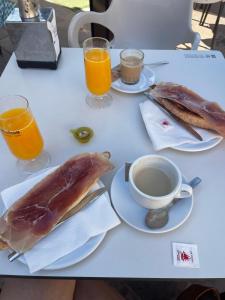 a table with two plates of food and a cup of coffee at Mar Menor Elisa Apartment in Santiago de la Ribera