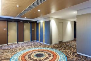 a lobby with a large rug on the floor at Calamvale Hotel Suites and Conference Centre in Brisbane