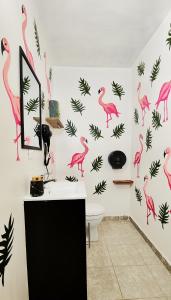 a bathroom with pink flamingos on the wall at MESON AMELIA in San Miguel de Allende