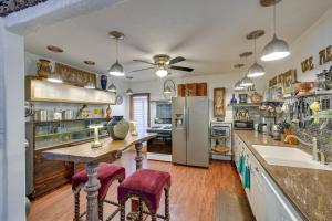 a kitchen with a table and a refrigerator at Bohemian Wonderland Benicia Bungalow with Pergola! in Benicia