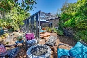 a backyard with chairs and a table and a house at Bohemian Wonderland Benicia Bungalow with Pergola! in Benicia