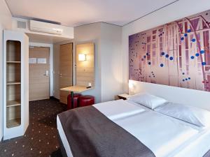 מיטה או מיטות בחדר ב-B&B Hotel Köln-Troisdorf