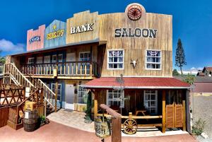 a large wooden building with a saloon at Pousada Vila do Cowboy in Penha