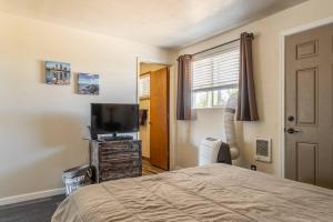 a bedroom with a bed and a flat screen tv at Immaculate, Cozy Home in Downtown Redmond in Redmond
