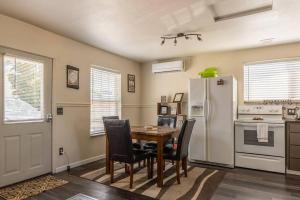 a kitchen with a table and chairs and a refrigerator at Immaculate, Cozy Home in Downtown Redmond in Redmond