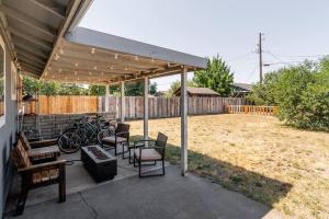 a pavilion with chairs and tables and bicycles on a patio at Immaculate, Cozy Home in Downtown Redmond in Redmond