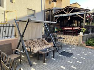 a bench and a table on a patio at Eforie Brio in Eforie Nord