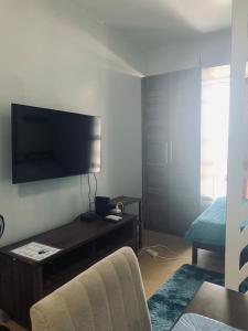 a living room with a flat screen tv on the wall at Condo in Avida tower IT park , Lahug Cebu city, Fully furnished in Cebu City