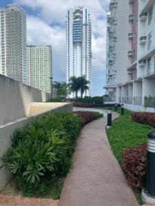 a walking path in a city with tall buildings at Condo in Avida tower IT park , Lahug Cebu city, Fully furnished in Cebu City