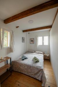 ein Schlafzimmer mit einem Bett und zwei Fenstern in der Unterkunft Great Escape Olympia in Olympia