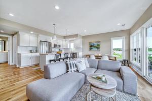 a living room with a couch and a kitchen at Hot Tub - Saugatuck/Douglas - Three Bedroom - Sleeps 8 in Douglas