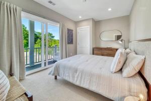a bedroom with a bed and a large window at Hot Tub - Saugatuck/Douglas - Three Bedroom - Sleeps 8 in Douglas