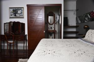 1 dormitorio con 1 cama y puerta de madera en La Estancia Hotel Boutique en Salamina