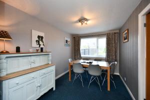 a kitchen with a table and chairs and a window at Links Golf Villa in Troon
