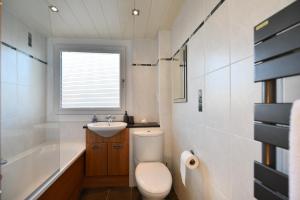 a bathroom with a toilet and a sink at Links Golf Villa in Troon +11 photos