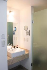 a bathroom with a white sink and a mirror at Hotel México Plaza Irapuato in Irapuato