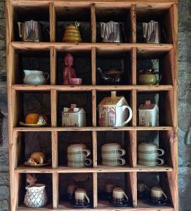 a wooden hutch filled with lots of pots and pans at Bed and Breakfast Ballallaluna in Maiolo