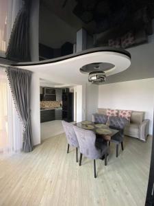 a living room with a table and chairs and a couch at Suite Apartment in Šiauliai