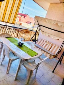 a table and chairs on a balcony with a view at Belvedere House Holiday Siracusa Ortigia in Belvedere