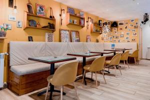 a row of tables and chairs in a restaurant at Pierre & Vacances Aparthotel La Tulipa in Ordino +52 photos