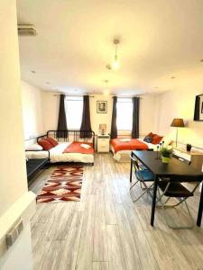 a large living room with a bed and a table at Spacious Studio flat in Central London in London