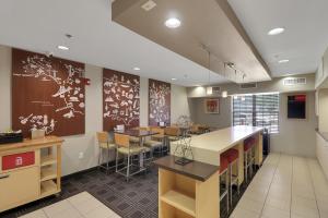 a restaurant with tables and chairs in a room at TownePlace Suites by Marriott College Station in College Station