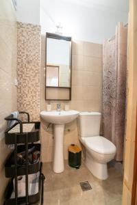 a bathroom with a toilet and a sink and a mirror at Joanna Luxury Apartment in Preveza +28 photos