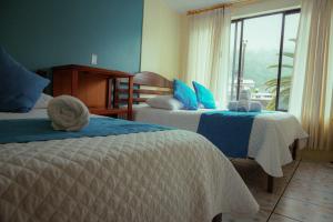 Voodi või voodid majutusasutuse Hostal CañaLimeña toas